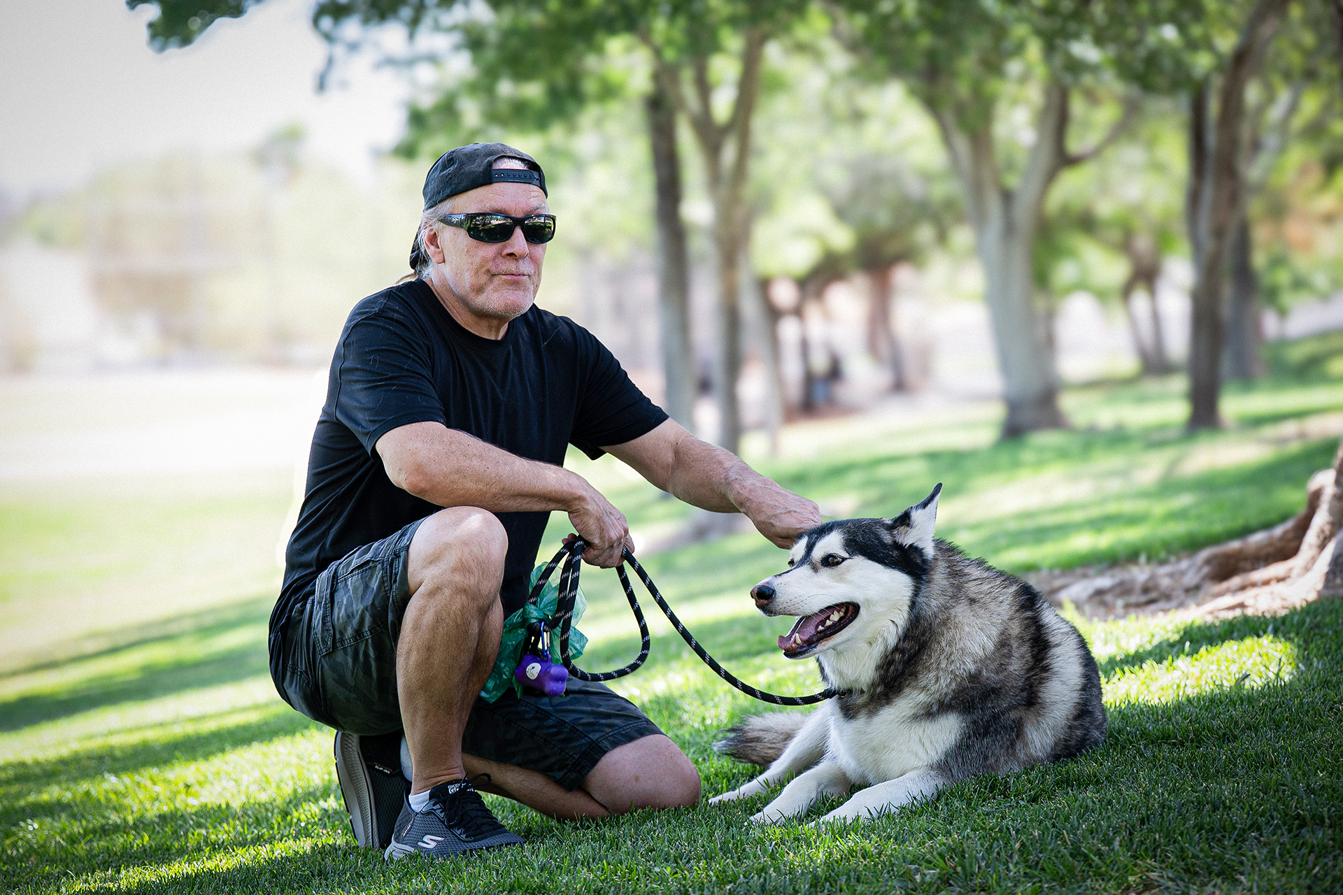 Current photo Rob with dog at park where he spends most of his time