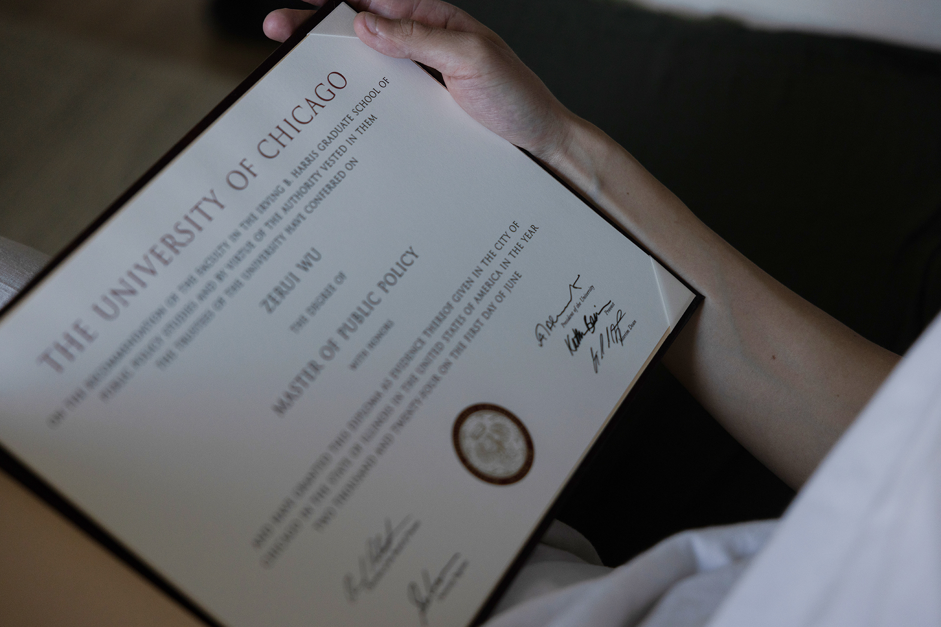 Zerui holds his diploma from the University of Chicago - Master of Public Policy