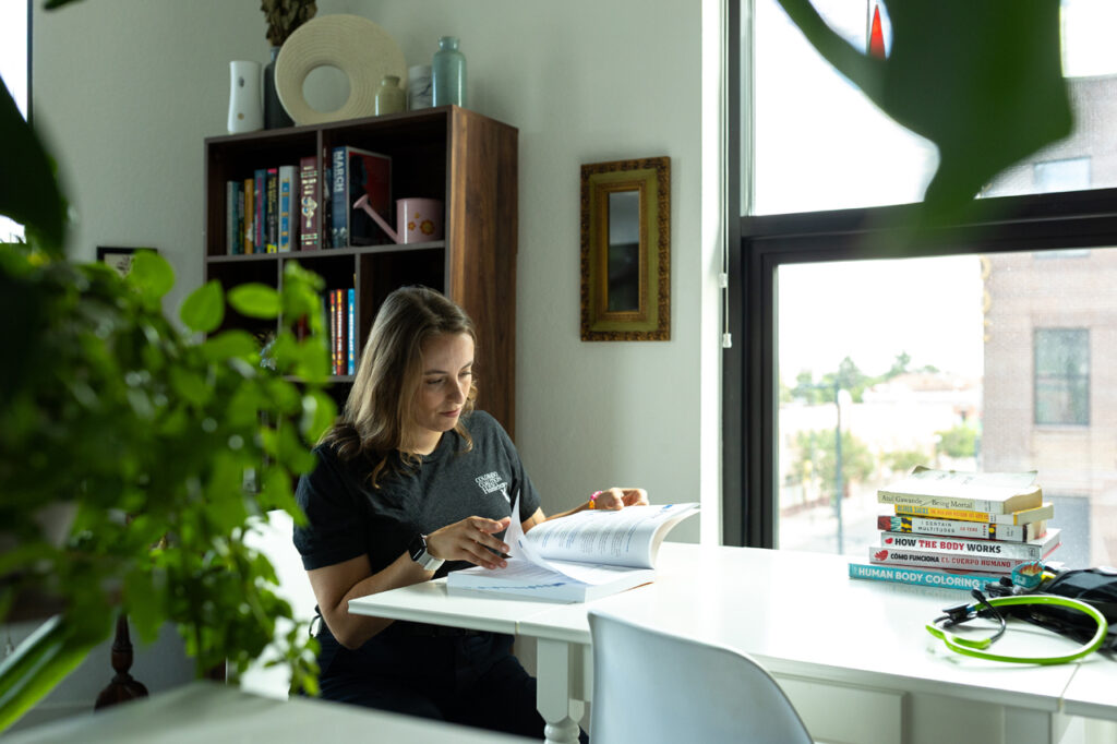 Angel reads at their table at home
