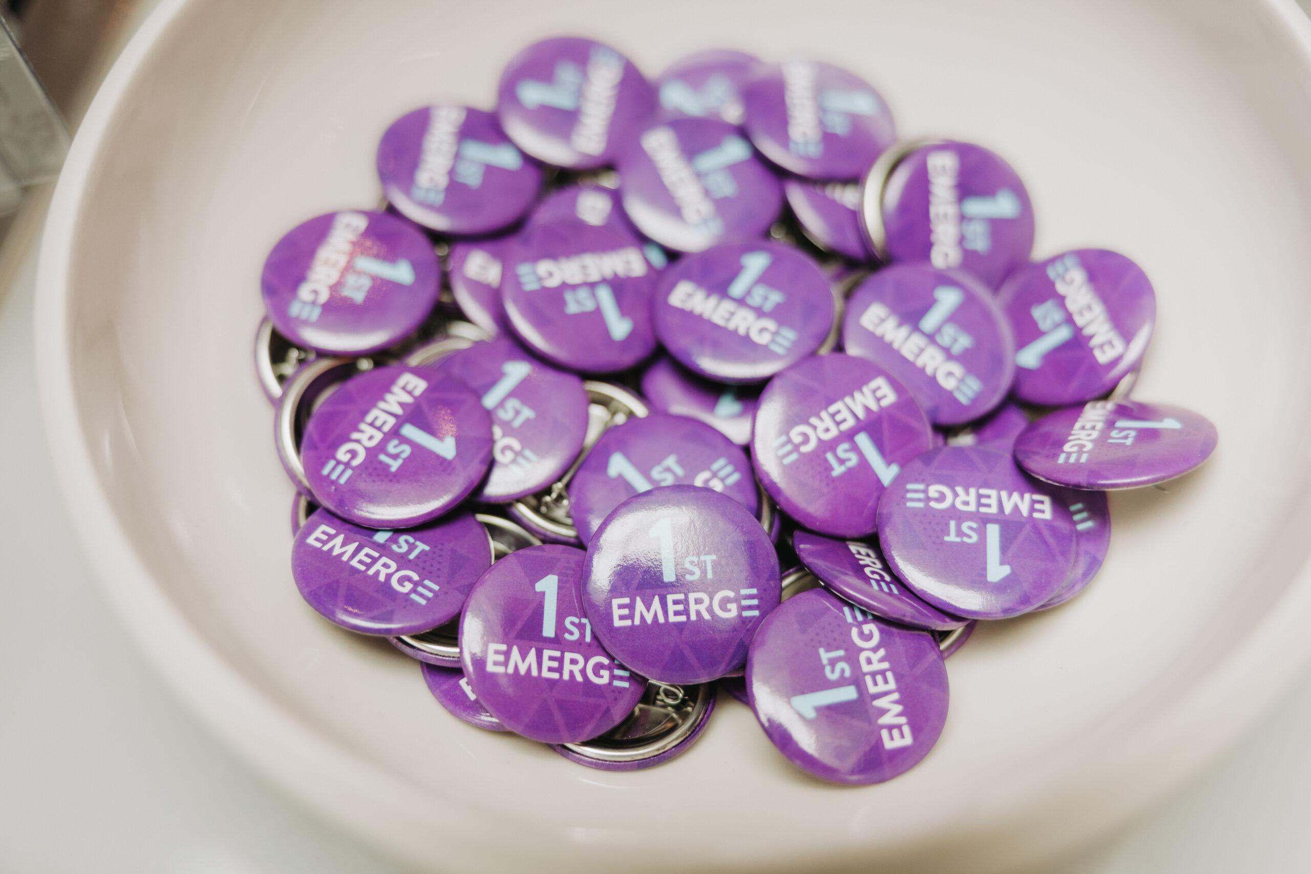 first EMERGE buttons in a bowl at registration