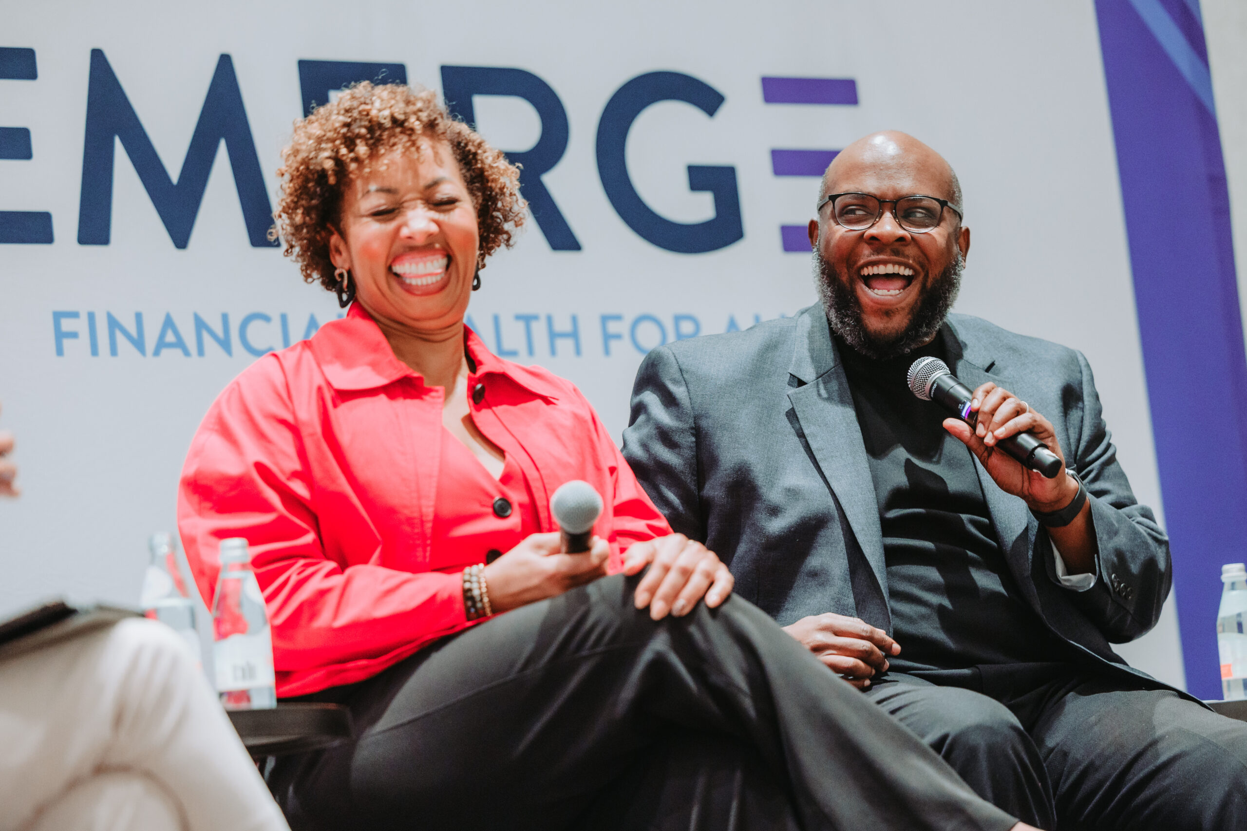 Speakers smile on stage during a breakout session at EMERGE Financial Health 2026
