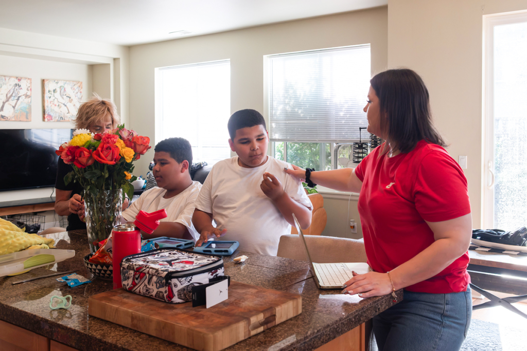 Ashley and her mother help her boys get ready for school